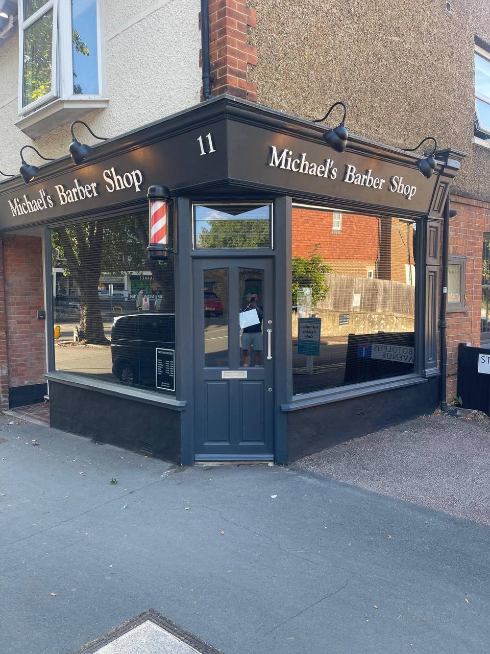 The dark grey frontage of Michael's Barber Shop