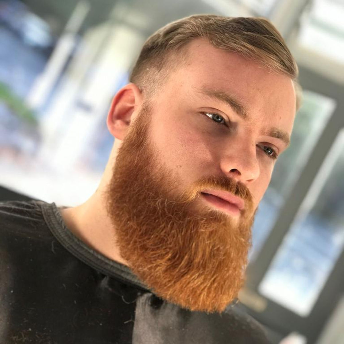 A customer with a freshly styled beard and haircut